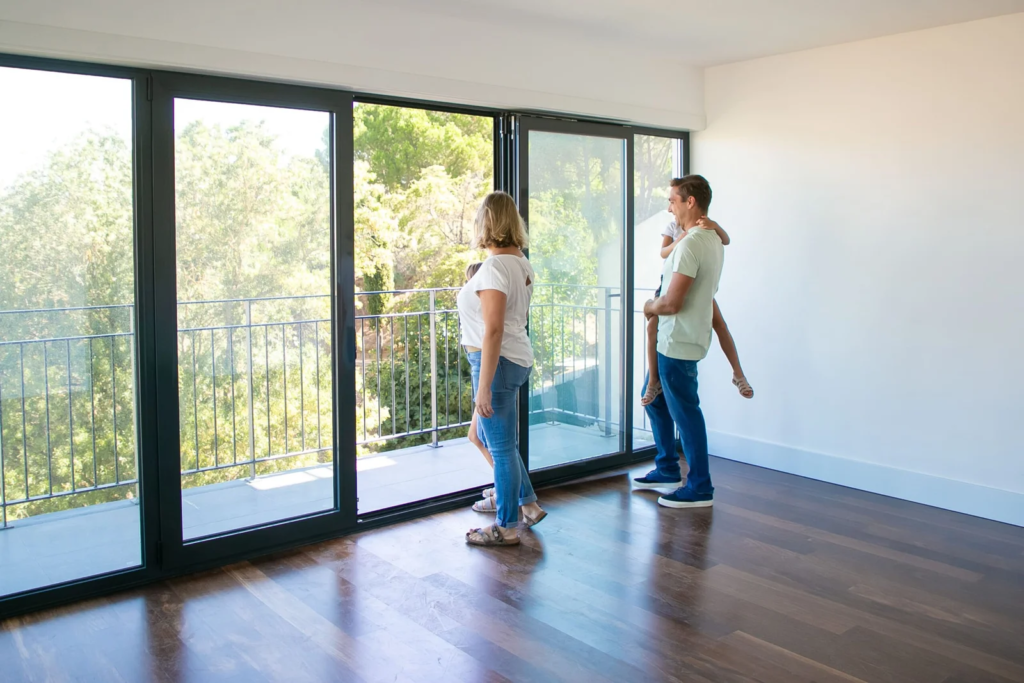 happy-family-with-kids-looking-balcony-smiling-scaled
